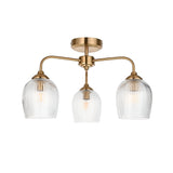 Endon Halstead Ribbed 3 light semi-flush ceiling light in aged brass with three curved arms and ribbed clear glass shades, on a white background.