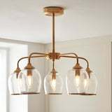 Halstead 5 Light Pendant in brass with arched arms and clear glass shades edged in metal trim, shown fitted to a ceiling in a light-toned room.