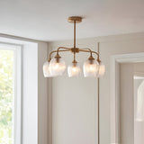 Endon Halstead Ribbed 5 Light semi-flush pendant in brushed brass with fluted clear glass shades on curved arms, installed in a bright neutral room.