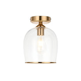 Halstead flush ceiling light in aged brass with a clear dome glass shade and exposed E27 bulb, shown on a plain white background.