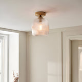 Endon Halstead flush ceiling light with ribbed glass shade and aged brass fitting, mounted on a hallway ceiling beside a cream panelled wall.