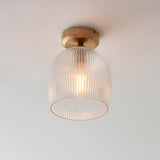 Endon Halstead flush ceiling light with ribbed clear glass dome shade and aged brass fitting, mounted to a plain white ceiling.