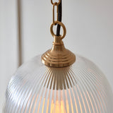 Close-up of Endon Halstead Ribbed Pendant in brass, showing the fluted clear glass dome shade, brushed brass cap and chain with black braided flex.