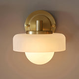 Endon Ashby wall light in brushed aged brass with a frosted glass outer shade layered over a matt opal glass sphere, mounted on a round backplate.