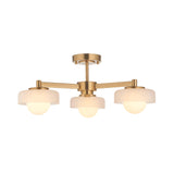 Endon Ashby 3 light semi-flush ceiling light in aged brass with three white glass shades on radial arms, shown on a plain white background.