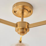 Close-up of the Endon Rutland semi-flush ceiling light showing the aged brass canopy, central hub and three arms against a white ceiling.