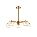 Rutland 5-light pendant in brushed aged brass with five ribbed clear glass shades on angled arms and a telescopic stem, shown on a white background.