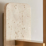 Bramble Wall Light in brass and natural stone, close-up of the textured travertine backplate with brass bracket against a plain wall.