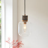 Cranstead Pendant Light in brass and brown with marble top, brass collar, and rounded clear glass shade showing an E27 bulb.