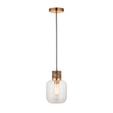 Cranstead single pendant light with brown marble collar, brass fitting, and clear rounded glass shade, hung on a black cord against a white background.