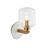 Cranstead Wall Light in Brass & White featuring a round white marble backplate, brass arm and clear glass shade with visible bulb, shown on a plain background.