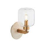 Endon Cranstead wall light with round natural travertine backplate, brass arm, and clear glass shade with E14 filament bulb, on a white background.