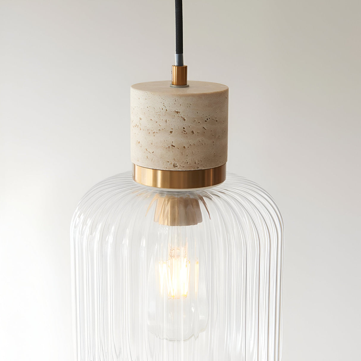 Cranton Pendant Light in brass and natural stone, featuring a ribbed clear glass shade and E27 bulb, shown against a plain light background.