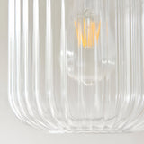 Close-up of the Cranton Pendant Light's ribbed clear glass shade with visible E27 filament bulb and brass fitting, on a plain light background.