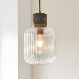 Endon Cranton pendant light with clear ribbed glass shade, brushed brass collar and dark brown Emperador marble top, lit by an E27 filament lamp.