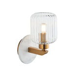 Cranton Wall Light in brass and white marble with ribbed clear glass shade, curved brass arm, and round marble backplate.