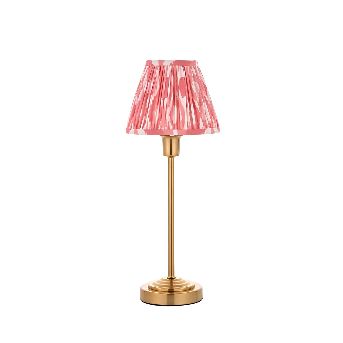 Endon Cliffbourne Ikat table lamp with slim brushed brass stem and stepped base, topped by a pleated coral pink ikat-print tapered shade, on white.