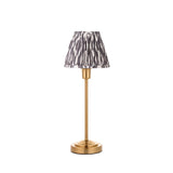 Cliffbourne Ikat Table Lamp with brass stepped base and pleated grey-and-white patterned fabric shade, shown on a plain white background.