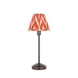 Endon Cliffbourne Zigzag table lamp with slim bronze stepped base and tapered pleated shade in apricot orange zigzag print, on a white background.