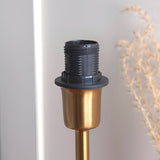 Close-up of the Cliffbourne Ivy Table Lamp's brass base and E14 bulb holder, showing the ribbed black fitting against a neutral background.