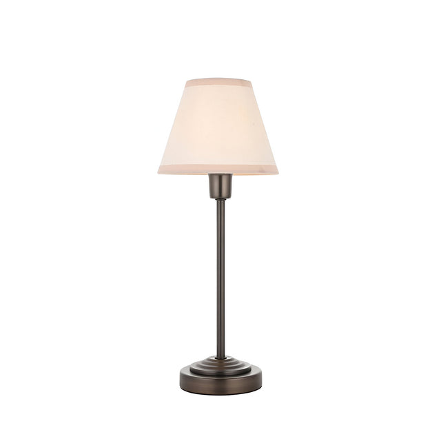 Endon Cliffbourne Ivy table lamp with slim antique bronze stepped base and tapered vintage white cotton shade with taped edge, on a white background.