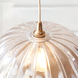 Close-up of the Endon Brackmont Carnation pendant showing the scalloped clear glass dome, brushed aged brass B22 fitting and natural braided cable.