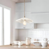 Brackmont Orchid Pendant in brass and clear ripple glass with a natural braided cable, shown lit above a light kitchen island.