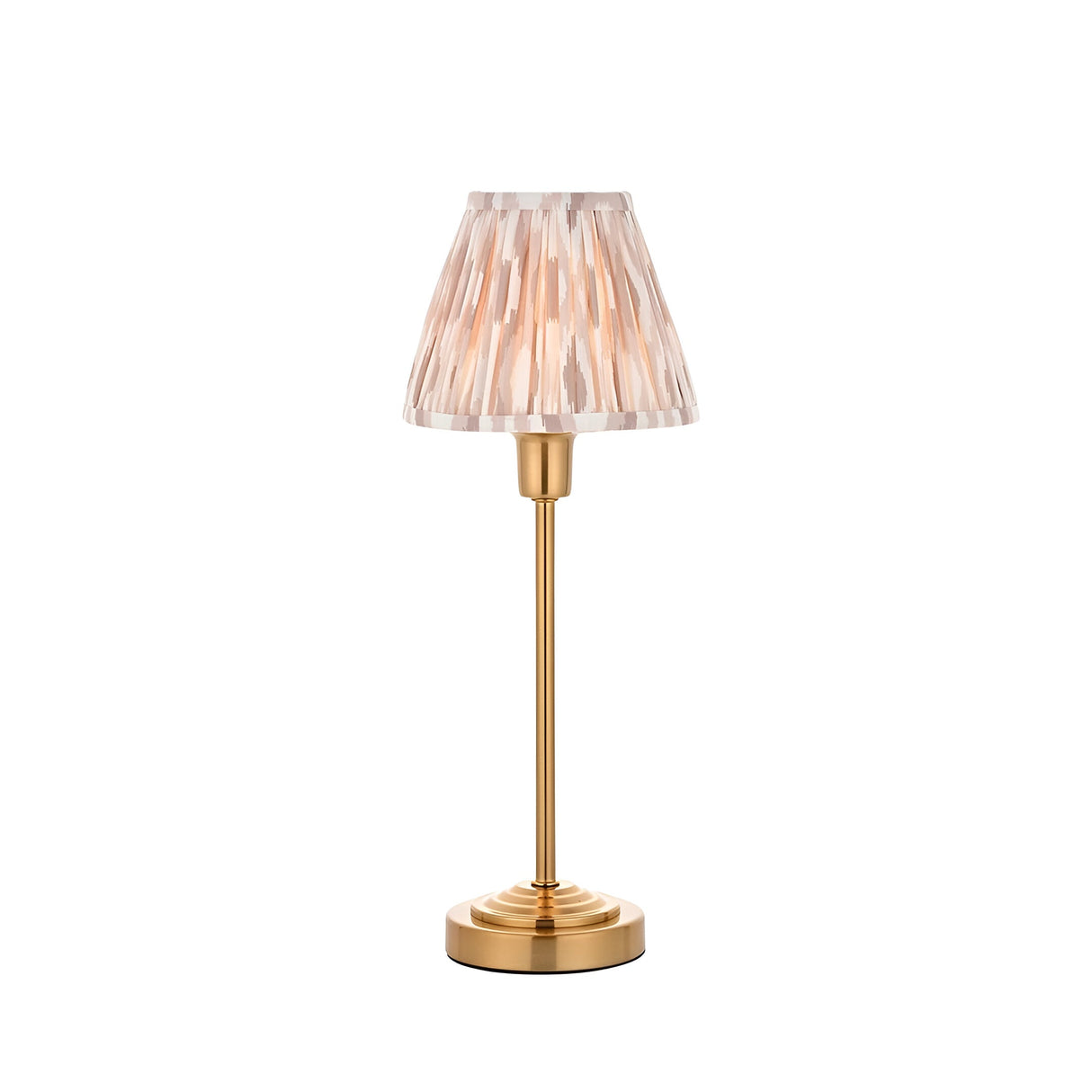 Endon Cliffbourne Ikat table lamp with brushed brass stepped base, slim stem, and pleated tapered Ikat shade in pink and grey tones on a white background.