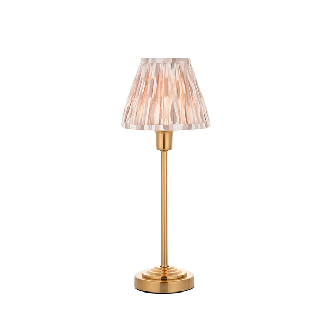 Endon Cliffbourne Ikat table lamp with brushed brass stepped base, slim stem, and pleated tapered Ikat shade in pink and grey tones on a white background.