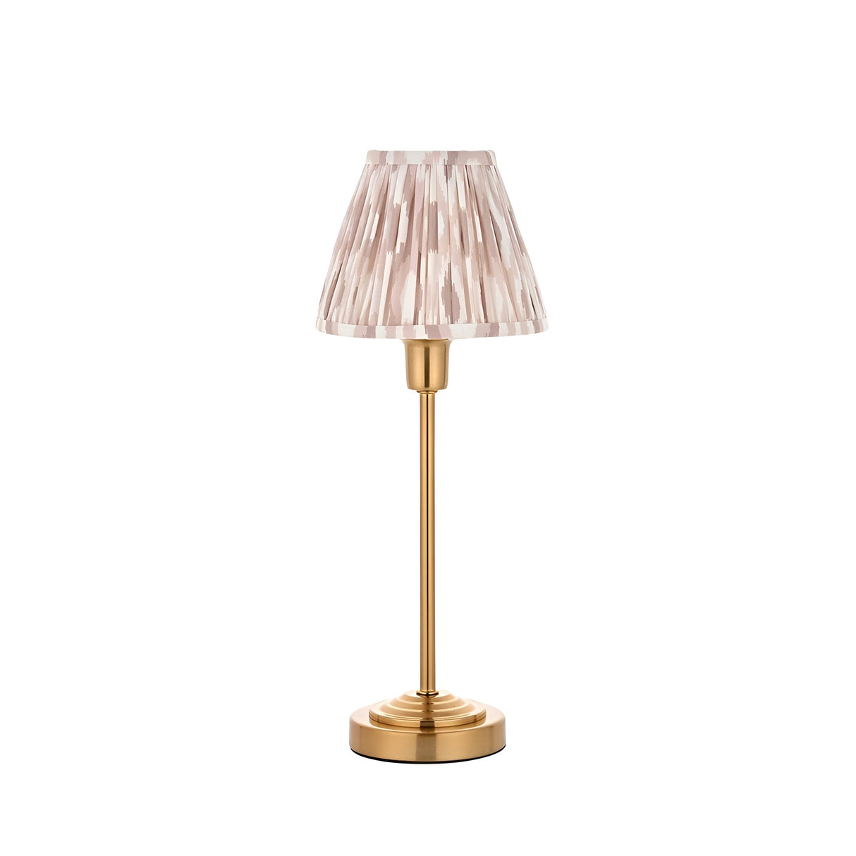 Endon Cliffbourne Ikat table lamp with brushed brass stepped base and pleated pink ikat-print tapered fabric shade, shown on a white background.