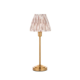 Endon Cliffbourne Ikat table lamp with brushed brass stepped base and pleated pink ikat-print tapered fabric shade, shown on a white background.