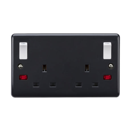 Introducing the 13A 2 Gang DP Switched Socket, a sophisticated and modern black double electrical outlet featuring two UK-style plug sockets. Each socket is equipped with a red neon indicator light and distinctive white on/off switches above, ensuring both safety and style. Engineered to meet British Safety Standards, this design also includes twin earths and outboard rockers, making it Part M compliant for enhanced functionality.