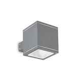 The Opus Square Outdoor Wall Light - Anthracite is a minimalist fixture designed in a square shape, mounted on a bracket, with a sleek anthracite finish and features a flat Pyrex glass panel on the bottom for illumination.