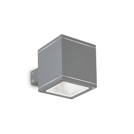 The Opus Square Outdoor Wall Light - Anthracite is a minimalist fixture designed in a square shape, mounted on a bracket, with a sleek anthracite finish and features a flat Pyrex glass panel on the bottom for illumination.