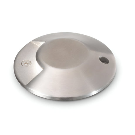 The Gleamora-1 LED Outdoor Drive Over Recessed Ground Light 3W 4000K in Grey is a flat, round object with a brushed metallic finish and a small hole near the edge. It features a slightly raised center and has an IP65 rating, along with a subtle logo etched into a notch on one side, making it distinctive against the plain white background.