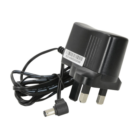 AV:Link UK power supply with black casing, three-pin plug and right-angled DC connector on a coiled cable, shown on a plain white background.