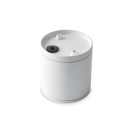 The Solar Downlight - White features a minimalist cylindrical container with a flat top and two small holes, one of which is black. Its sleek design, reminiscent of stylish bathroom lighting, stands out against a plain white background.