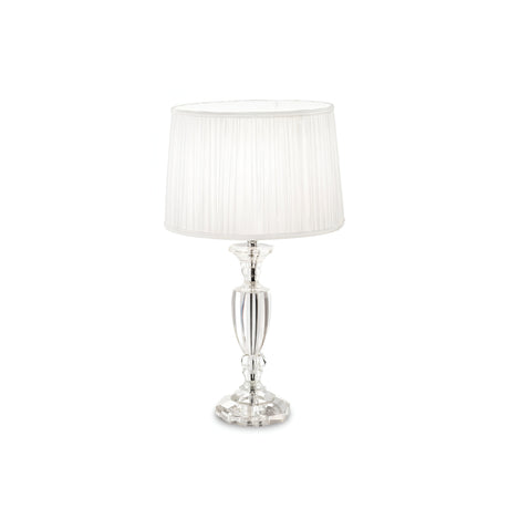 The Serene 3 Crystal Table Lamp - White features a transparent, faceted crystal base paired with a white pleated lampshade. This luxurious piece of lighting beautifully reflects light through the crystal, offering a sophisticated and decorative appearance ideal for enhancing elegant home decor.