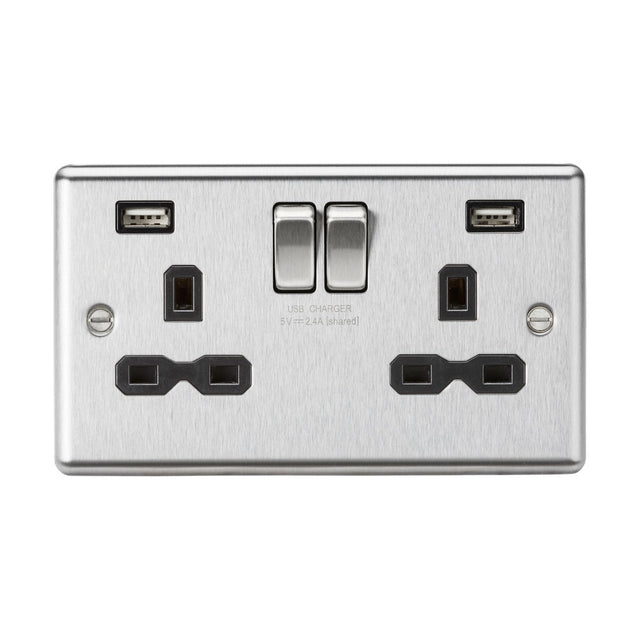 The 13A 2 Gang SP Switched Socket With Dual USB in brushed chrome, featuring a black insert and rounded edge, offers two standard three-pin plug outlets alongside a dual USB charger. It includes individual switches for each outlet, blending modern design with functionality to enhance both efficiency and style.