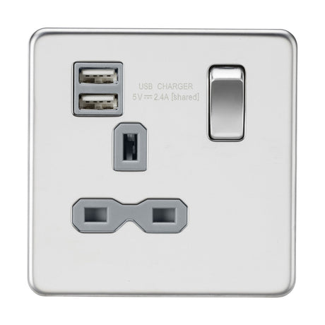 A 13A switched socket with a single switch, dual USB ports labeled USB Charger 5V 2.4A shared, and a universal power outlet features a polished chrome, screwless design with a grey insert, combining sleek minimalism with functionality.