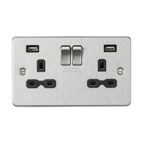 This dual electrical wall socket, known as the 13A 2 Gang SP Switched Socket With Dual USB - Brushed Chrome (Black Insert, Flat Plate), showcases a brushed chrome finish. It features two UK plug outlets along with a dual USB charger. The sleek flat plate design seamlessly integrates two switches that provide control over the power to the outlets, merging functionality with a contemporary look.