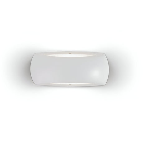 The Muse Outdoor Light Wall Light in grey boasts a minimalist and modern design with a frosted glass shade that emits a soft glow. Constructed from durable resin and featuring an IP66 rating, its slightly curved rectangular form is elegantly mounted against a smooth, white wall.
