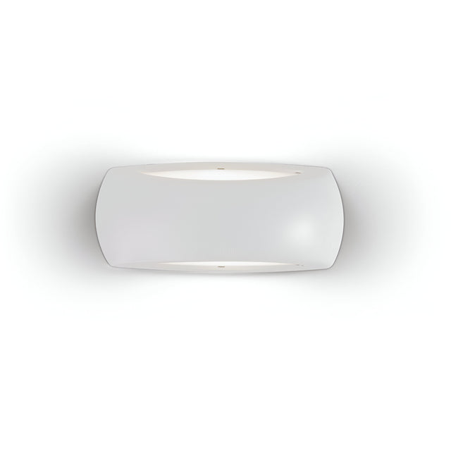 The Muse Outdoor Light Wall Light in grey boasts a minimalist and modern design with a frosted glass shade that emits a soft glow. Constructed from durable resin and featuring an IP66 rating, its slightly curved rectangular form is elegantly mounted against a smooth, white wall.