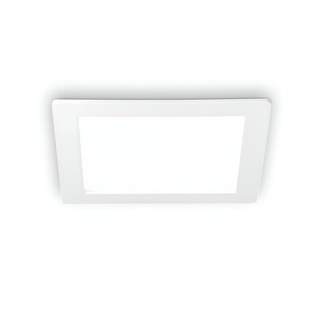 The Focus Square Recessed Downlight - 30W, featuring a minimalist white frame, utilizes an energy-efficient LED to emit a gentle glow at 3000K, softly illuminating the plain white background.