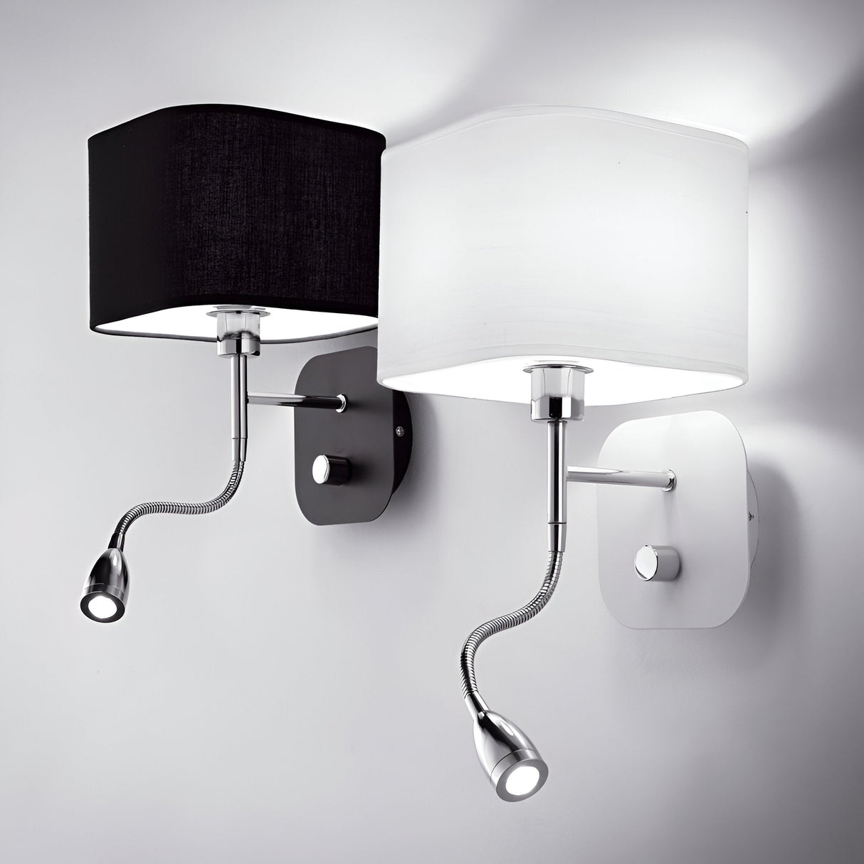 The Olympia LED Wall Light set includes two contemporary wall-mounted lamps with square shades—one in black and the other in white. Each lamp is equipped with an integrated reading light positioned beneath it and is attached to sleek matching wall plates, featuring easy-to-use on/off switches. These lights perfectly capture the essence of modern design.