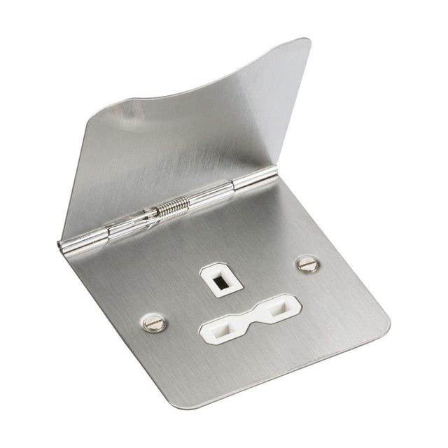 A 13A 1 Gang Unswitched Floor Socket in brushed chrome, complemented with a white insert, features mounting holes and a keyhole cutout for secure installation over a thermostat or control, offering durability similar to that of premium-grade steel.