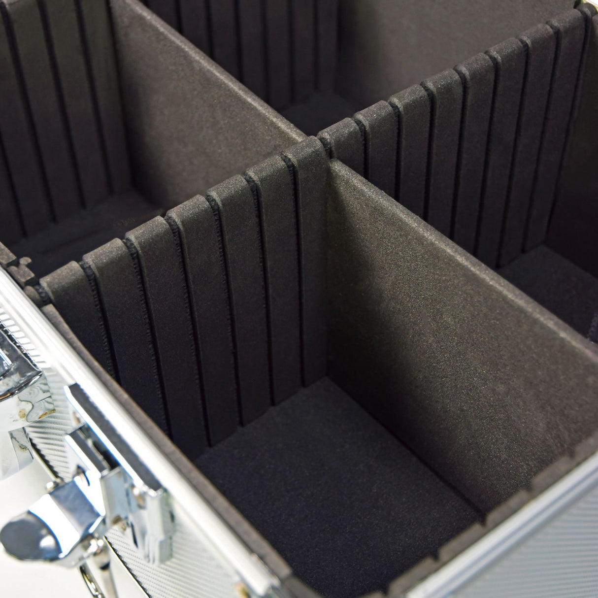 Close-up of the Citronic CDA:60 aluminium CD flight case interior showing black padded foam separators, lined compartments, and chrome-plated hardware.