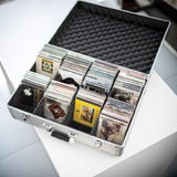 Citronic CDA:120 aluminium CD flight case open on a white surface, filled with CDs in padded separators and chrome catches on the front.
