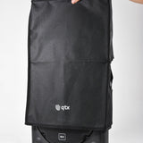 QTX QR12COVER water-resistant black slip cover fitted over a QR-series speaker cabinet with side handle access hole, held at the top against a plain background.