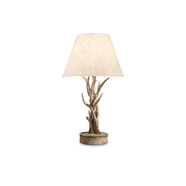 Introducing the Flow Wood Table Lamp - Dark Brown, featuring a beige, textured lampshade. Its faux tree branch design and resin base exude a rustic, nature-inspired charm. The piece stands elegantly on its round, wooden-like pedestal against a plain white background.